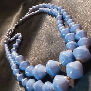 Layered Graduated wooden beaded necklace blue with gold spacers.